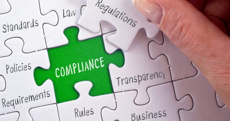 Green Background to White Puzzle Reads Compliance with Other Related Words Printed on Seperate Puzzle Pieces