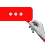 Art Collage of Isolated Black-White Hand Holding a Red Speech Bubble
