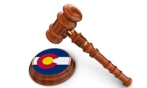 Colorado Flag Printed on Base of Judge's Wooden Mallet With Gavel Hovering Above