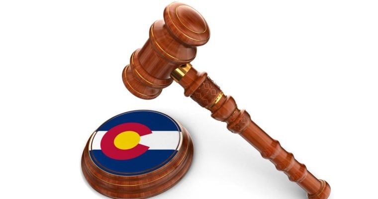 Colorado Flag Printed on Base of Judge's Wooden Mallet With Gavel Hovering Above