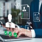 Man in Suit Sits At Desk Must Pass Identification Checks While Using Laptop