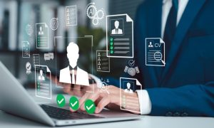 Man in Suit Sits At Desk Must Pass Identification Checks While Using Laptop