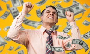 Cash Flies Around Excited Man With Fisted Hands Wearing Pink Button Down Shirt and Tie