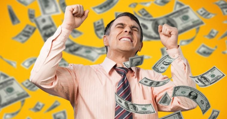Cash Flies Around Excited Man With Fisted Hands Wearing Pink Button Down Shirt and Tie