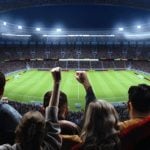 Soccer Stadium Filled With Cheering Fans Watching Nighttime Game Inside Stadium