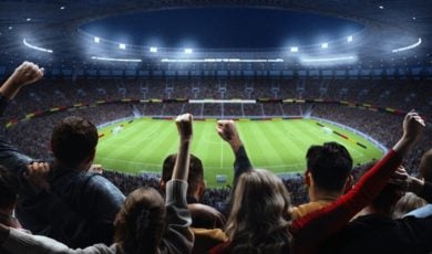 Soccer Stadium Filled With Cheering Fans Watching Nighttime Game Inside Stadium