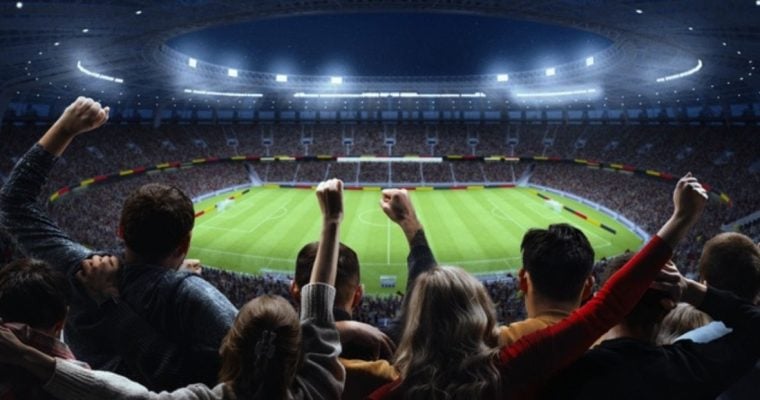 Soccer Stadium Filled With Cheering Fans Watching Nighttime Game Inside Stadium