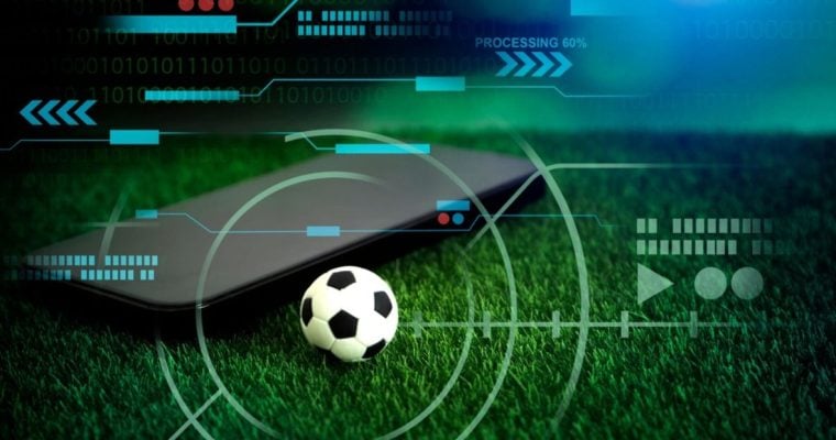 Green Grass with Mini Soccer Ball and Black Cell Phone in Sports Betting Concept