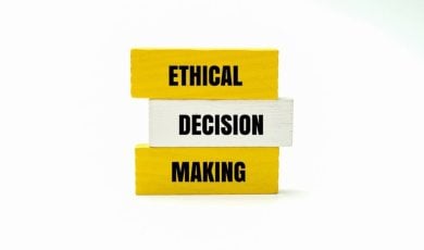 Yellow Wooden Blocks Say Ethical Making and One White Block Says Decision in the Middle