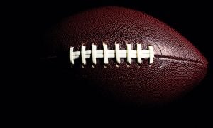 Close-Up Photo of Textured Brown American Football with White Stitching