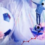Man Holds Soccer Ball in One Hand and TV Remote In Another With Smaller Man Balancing and Graphs Below