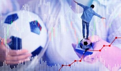 Man Holds Soccer Ball in One Hand and TV Remote In Another With Smaller Man Balancing and Graphs Below