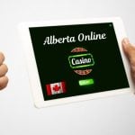 Tablet with Alberta Online Casino and Man Giving Thumbs Up with the Other Hand