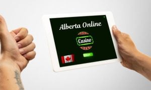 Tablet with Alberta Online Casino and Man Giving Thumbs Up with the Other Hand