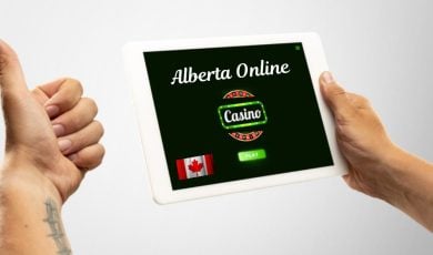 Tablet with Alberta Online Casino and Man Giving Thumbs Up with the Other Hand