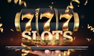 Gold Font Spells Slots and 777 on Black Reel Above Large Tablet Held in Man's Hand