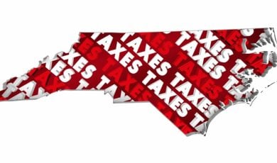 The Word Taxes in Red and White Font Fill An Outline of North Carolina State