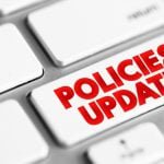 Computer Keyboard Button Reads Policies Update in Red Font
