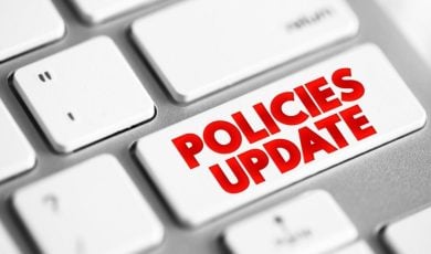 Computer Keyboard Button Reads Policies Update in Red Font