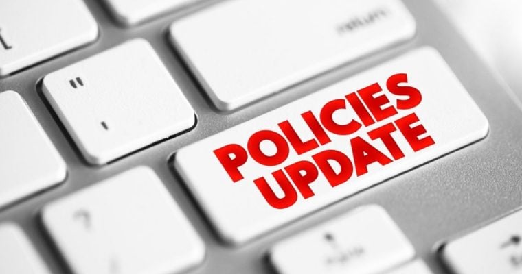 Computer Keyboard Button Reads Policies Update in Red Font