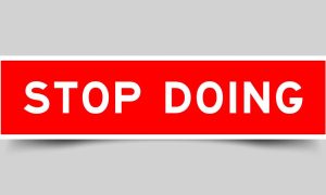 Red and White Rectangular Sign Reads Stop Doing