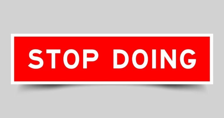 Red and White Rectangular Sign Reads Stop Doing