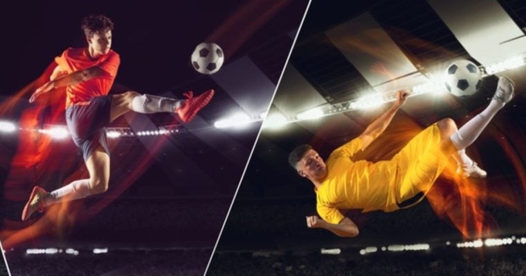 Two Young Male Soccer Players Mid-Air Kicking Ball Inside Stadium