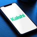 The Kalshi logo: Kalshi app on phone with safety alerts