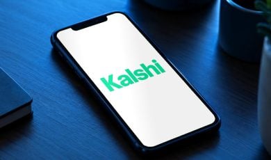 The Kalshi logo: Kalshi app on phone with safety alerts