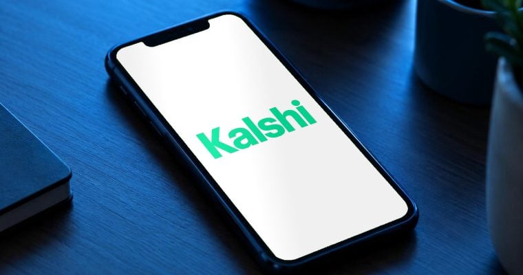 The Kalshi logo: Kalshi app on phone with safety alerts