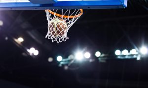 Basketball going through the hoop at a sports arena