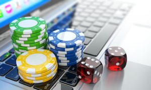 Online casino. Dices and chips on laptop.