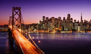 San Francisco skyline and Bay Bridge at sunset, California