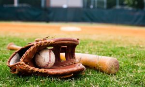 Old Baseball, Glove, and Bat on Field