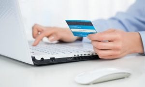 Close up of female hands makink online payment