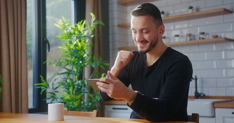 excited player winning a slots tournament on his mobile phone