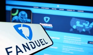 Picture of FanDuel logo on phone next to PC screen.