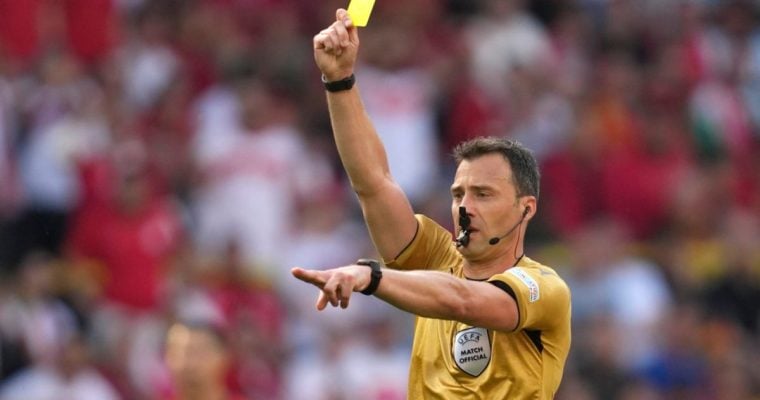 Soccer referee with yellow card