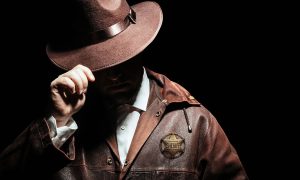 Tough-looking man with leather jacket and sheriff's badge