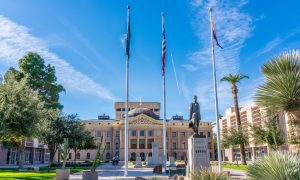 The Arizona State Capitol building is flanked by the State Senate and State House of Representatives buildings.