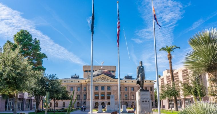 The Arizona State Capitol building is flanked by the State Senate and State House of Representatives buildings.