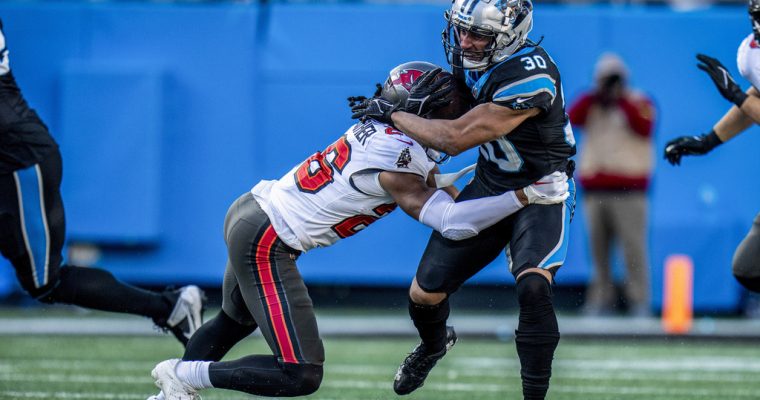 Carolina Panthers running back Chuba Hubbard is tackled in his game against the Tampa Bay Buccaneers in January 2024
