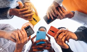 a group of people in a circle on their mobile phones