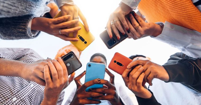 a group of people in a circle on their mobile phones