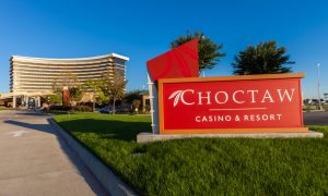 Entance sign of Choctaw Casino & Resort with the casino building in the background. The casino is owned by the Native American tribe Choctaw Nation of Oklahoma.