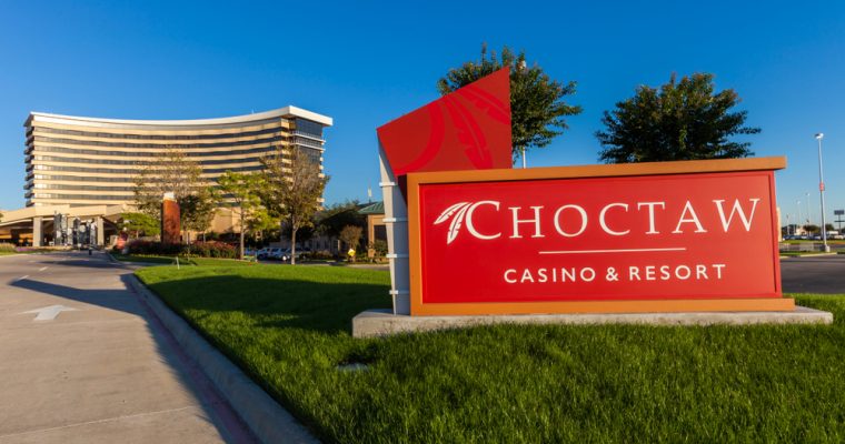 Entance sign of Choctaw Casino & Resort with the casino building in the background. The casino is owned by the Native American tribe Choctaw Nation of Oklahoma.