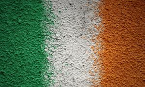 the irish flag painted over a concrete wall