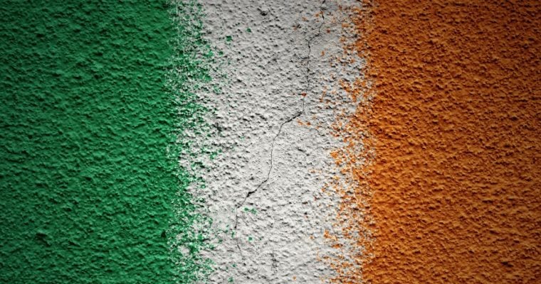 the irish flag painted over a concrete wall