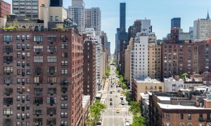 Overhead view First Avenue with traffic drivings through the buildings of Manhattan in New York City, as seen from the Roosevelt Island Tramway