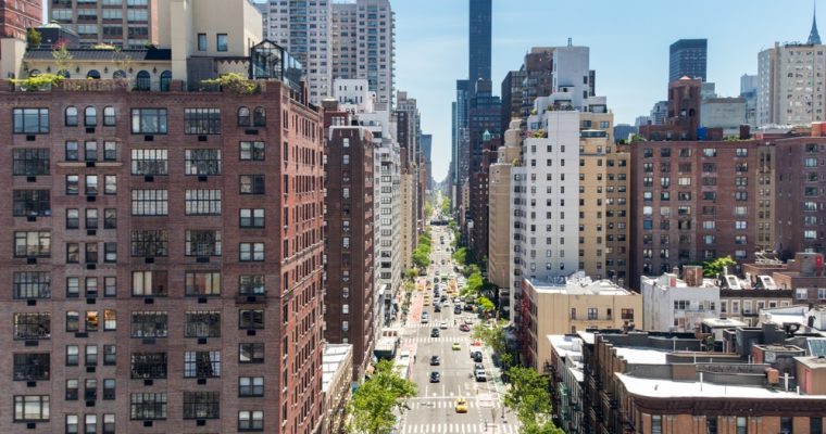 Overhead view First Avenue with traffic drivings through the buildings of Manhattan in New York City, as seen from the Roosevelt Island Tramway